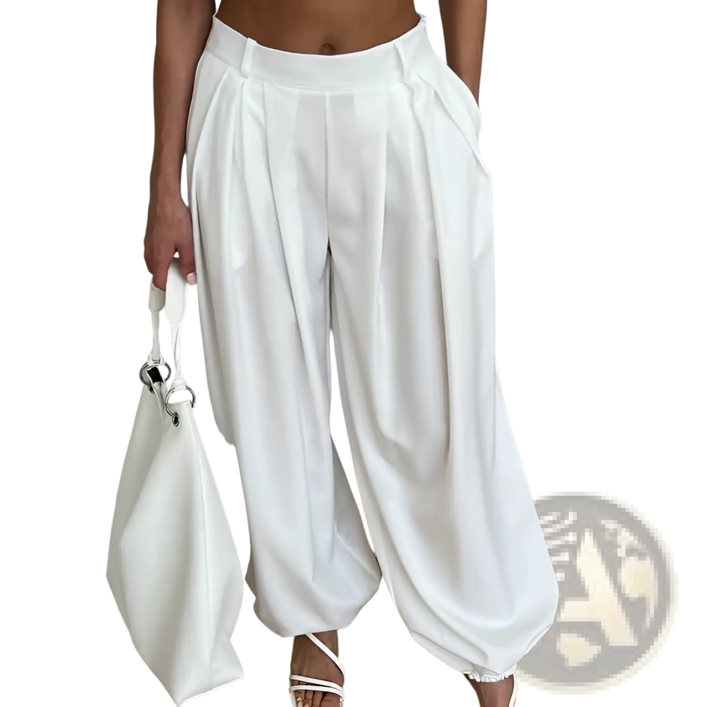 White high waisted balloon jogger pants with pleated wide-leg design and relaxed flowing silhouette in white fabric