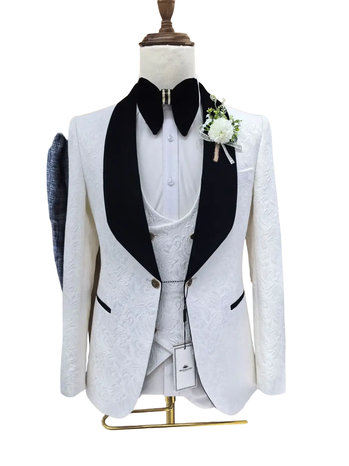 White jacquard tuxedo suit for men with black satin lapels and subtle floral embroidery displayed on a mannequin