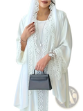Gray leather mini handbag with top handle and front flap closure complementing white lace trim abaya cardigan