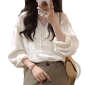 White lace v-neck blouse with delicate lace detailing and gathered puff sleeves in soft white fabric