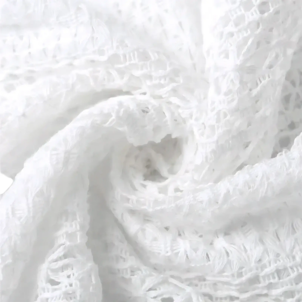 White lace v-neck long sleeve blouse featuring delicate intricate floral patterns and soft flowing fabric texture