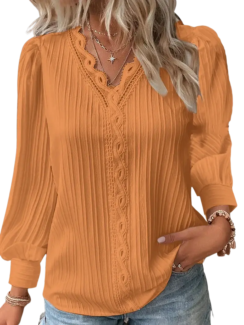 A soft orange synthetic fiber blouse with pleated texture and white lace detailing along the v-neckline