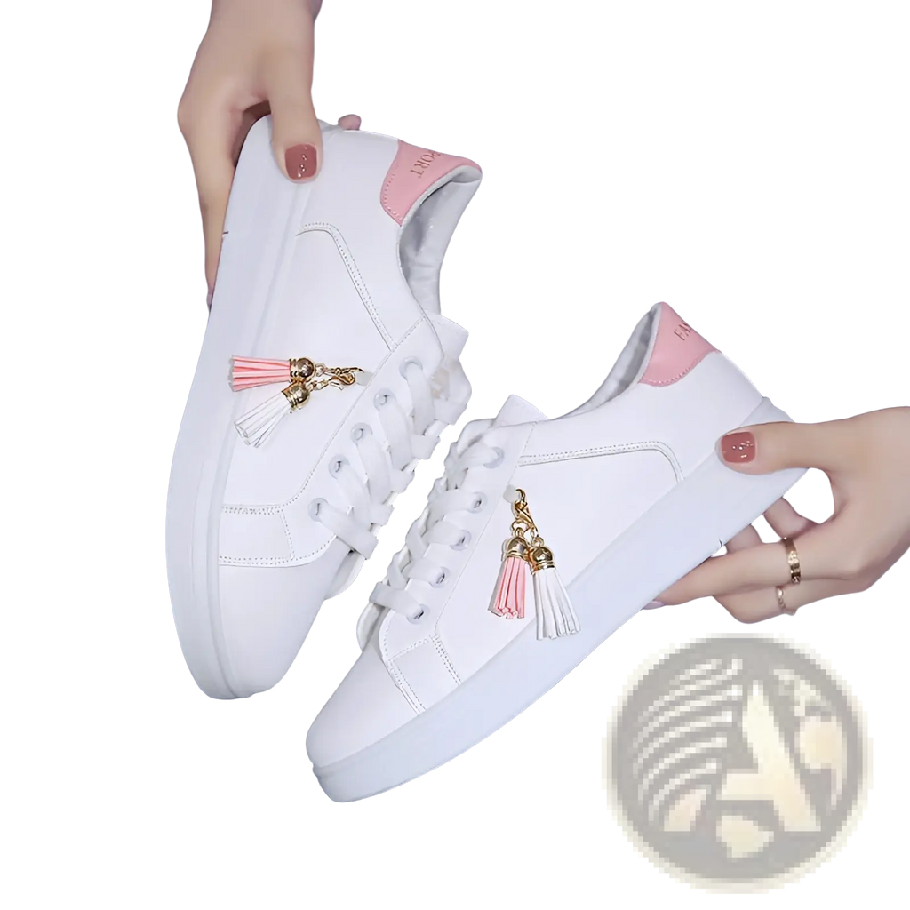 White leather tassel sneakers with pink tassel charms and matching pink heel tab for breathable sports use