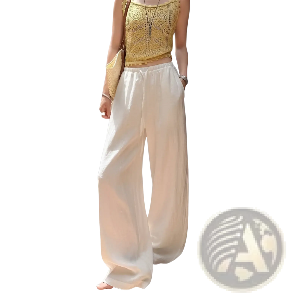 Cream-colored white linen wide leg pants with flowing fabric and a drawstring waist for comfortable wear