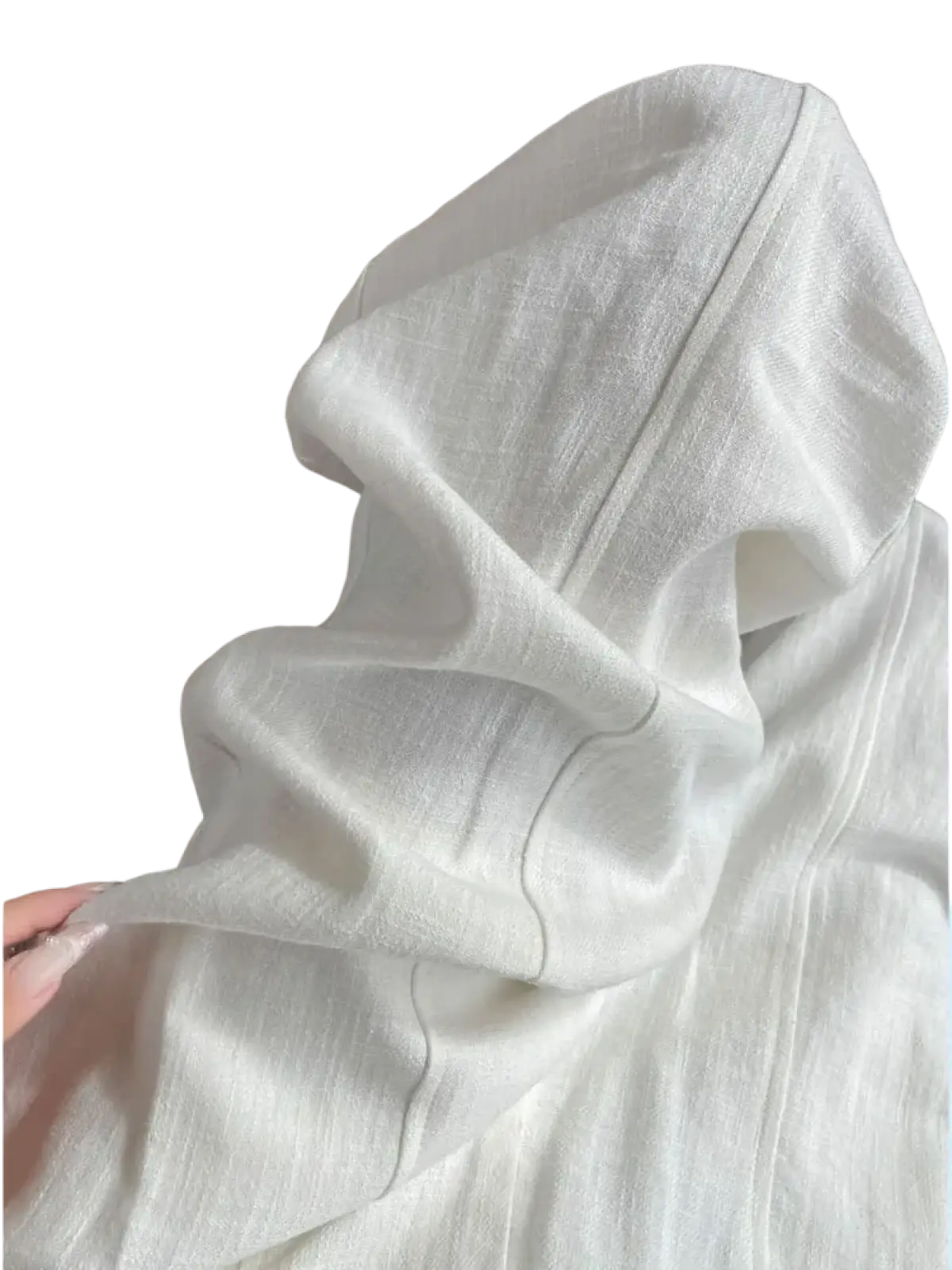 White hooded top in lightweight textured fabric with subtle stitching paired with white linen wide leg trousers