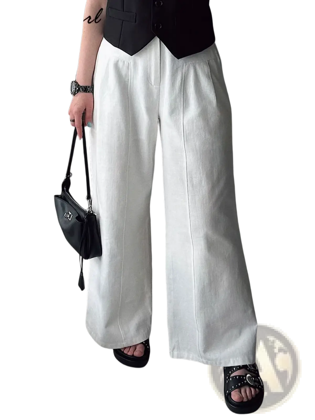 White linen wide leg trousers with a relaxed flowing silhouette and subtle vertical seam detailing