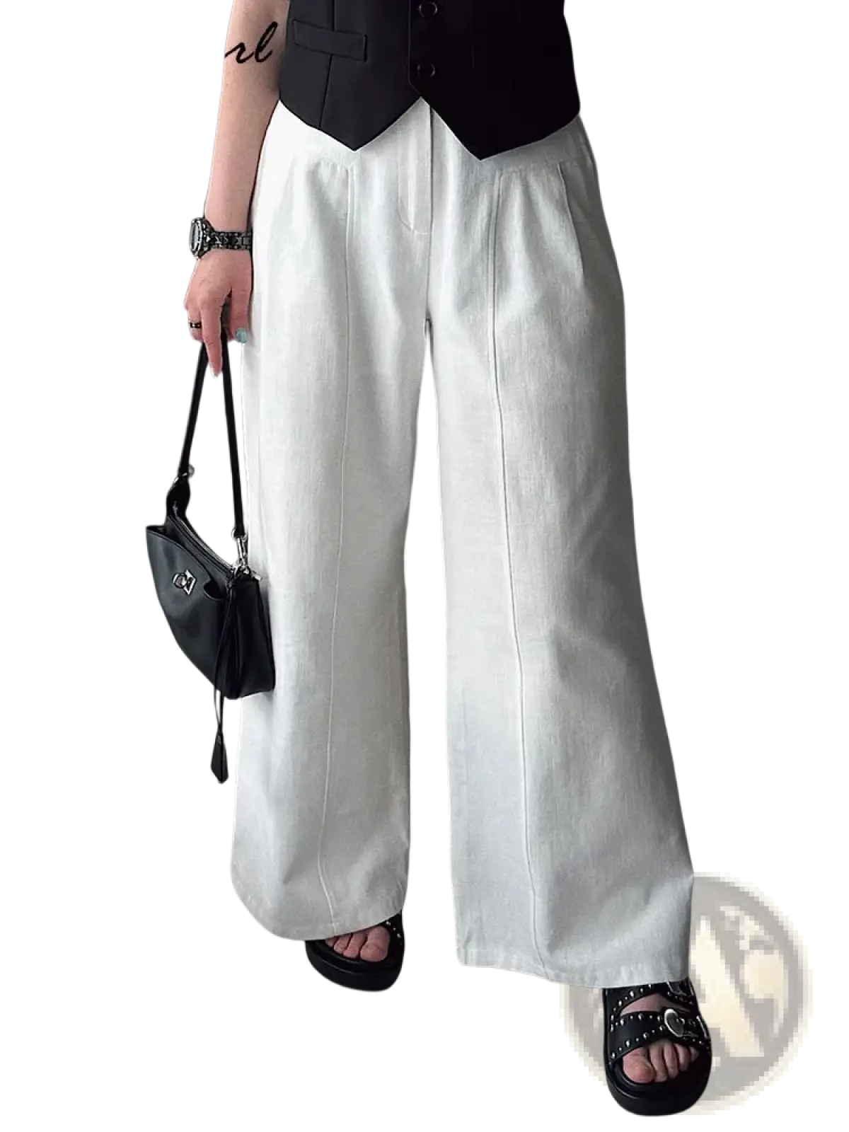 White linen wide leg trousers with a relaxed flowing silhouette and subtle vertical seam detailing