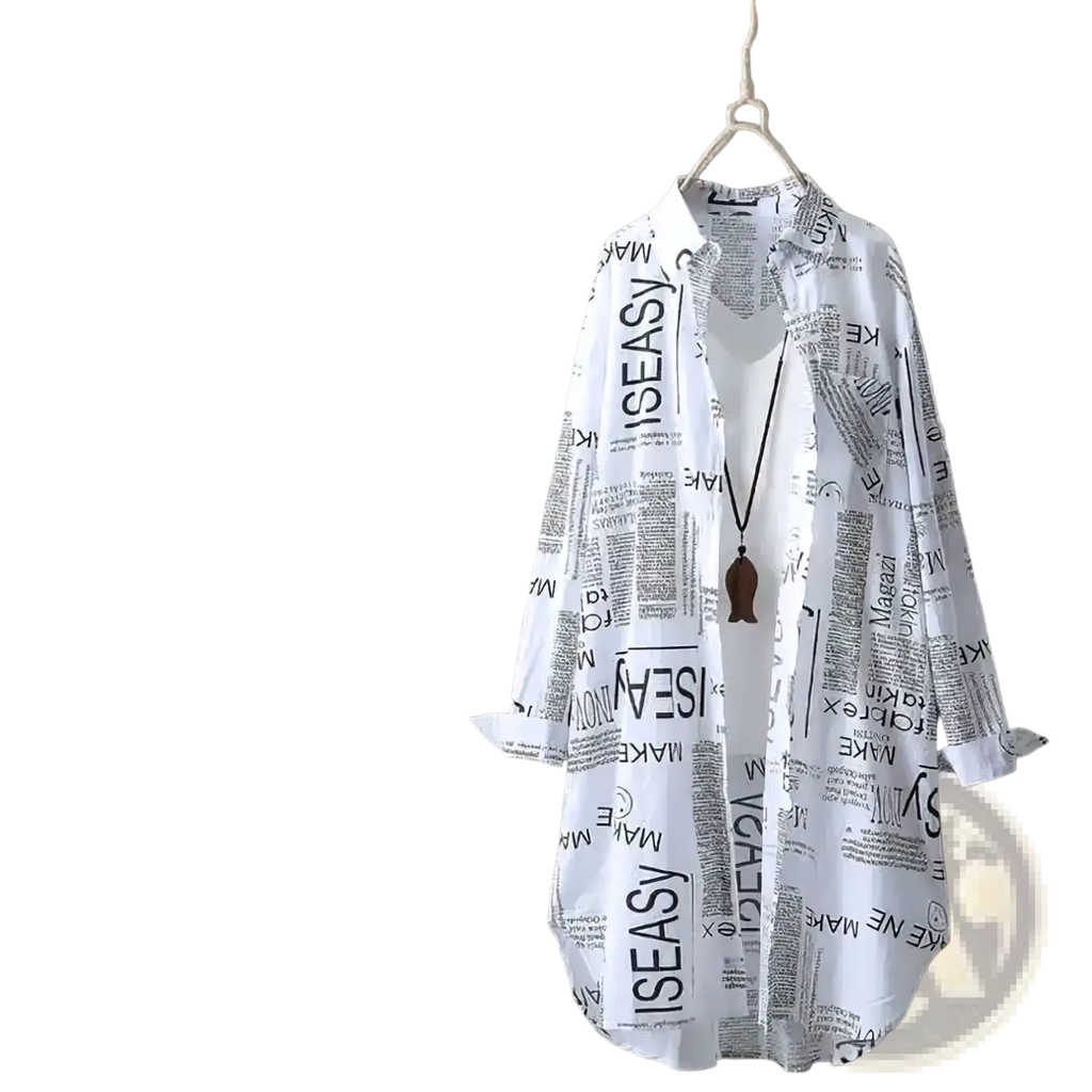 White newspaper print linen oversized shirt with long sleeves hanging on wooden hanger