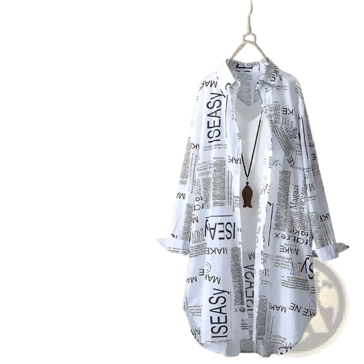 White newspaper print linen oversized shirt with long sleeves hanging on wooden hanger