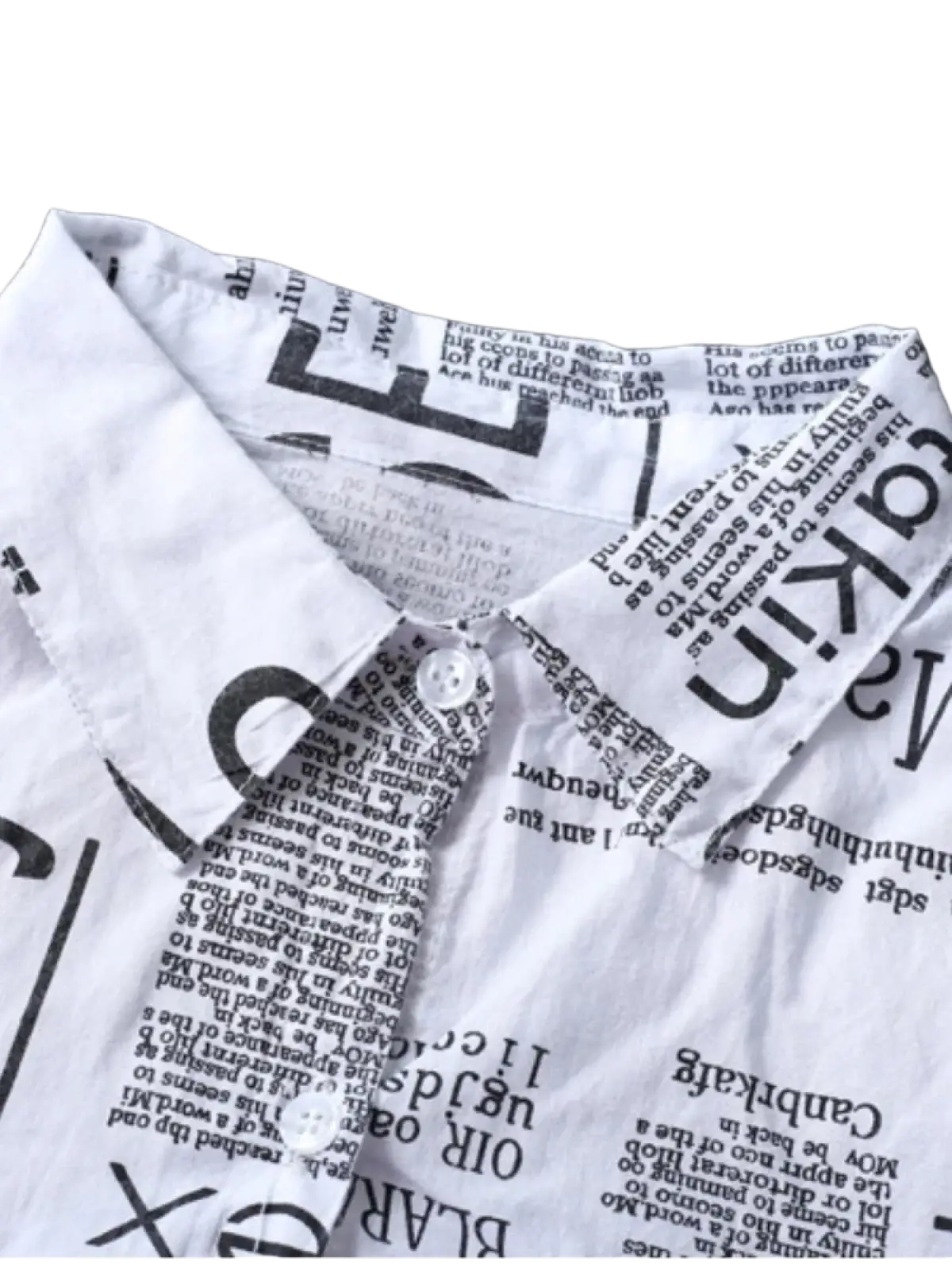 White linen oversized button-up shirt with black newspaper print design showcasing the front side