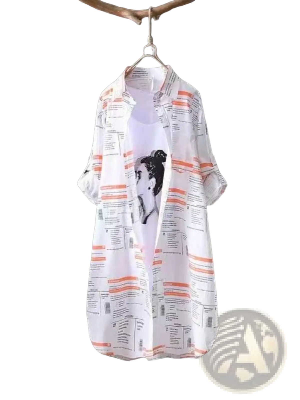 White newspaper print linen oversized shirt with orange and black sheer blouse hanging on wooden hanger