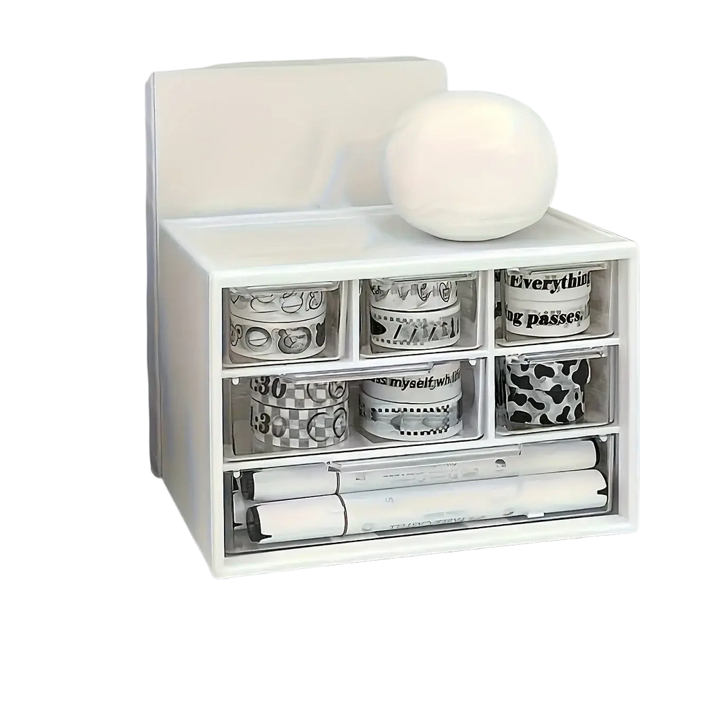 White plastic desk organizer with clear drawers holding rolls of washi tape and markers for desk storage