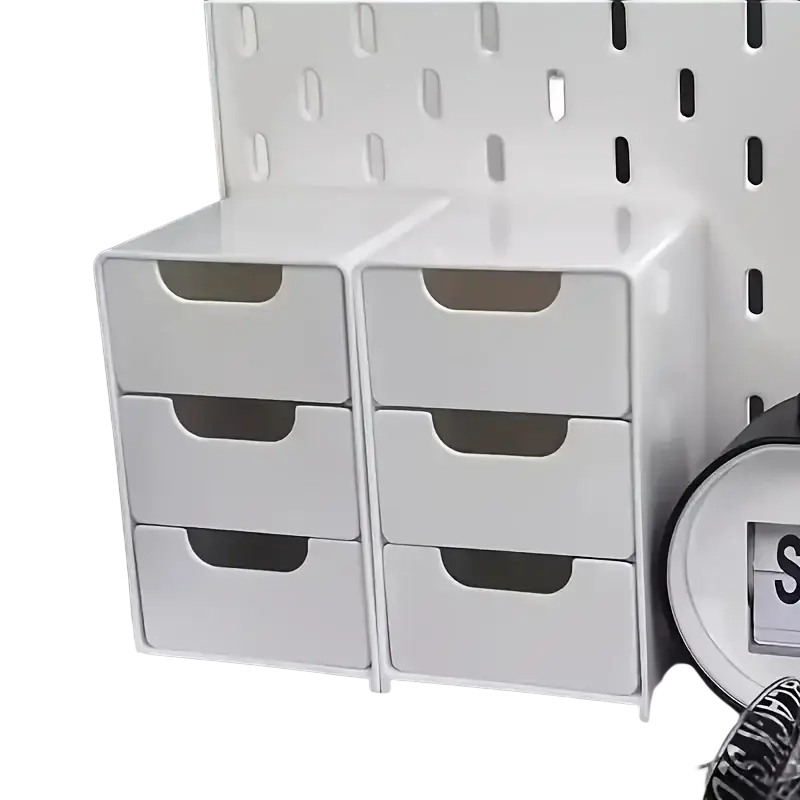 White plastic desk organizer with six drawers arranged three on each side for efficient office storage