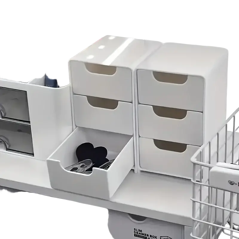 White plastic desk organizer with three slim stacked drawers and one open drawer containing black heart-shaped items