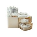 White plastic two-tier desk organizer with transparent drawers holding office supplies and makeup brushes