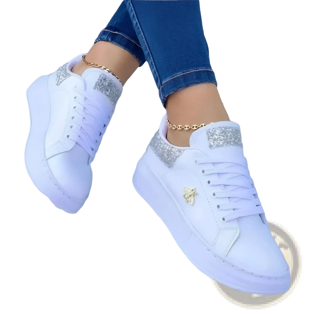 White platform sneakers featuring glittery silver accents and a gold bee emblem on the side