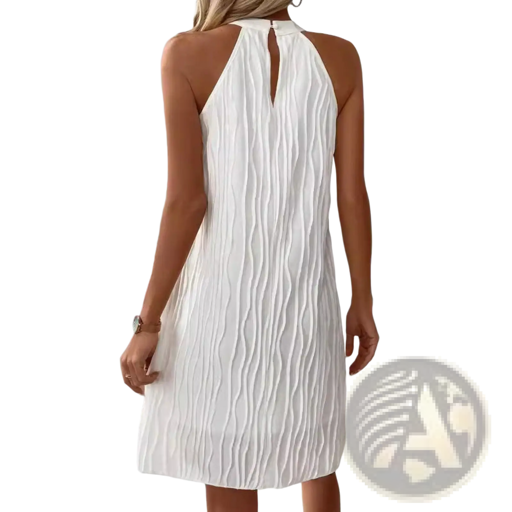 White pleated halter neck dress for women showing back keyhole detail and backless design in lightweight fabric