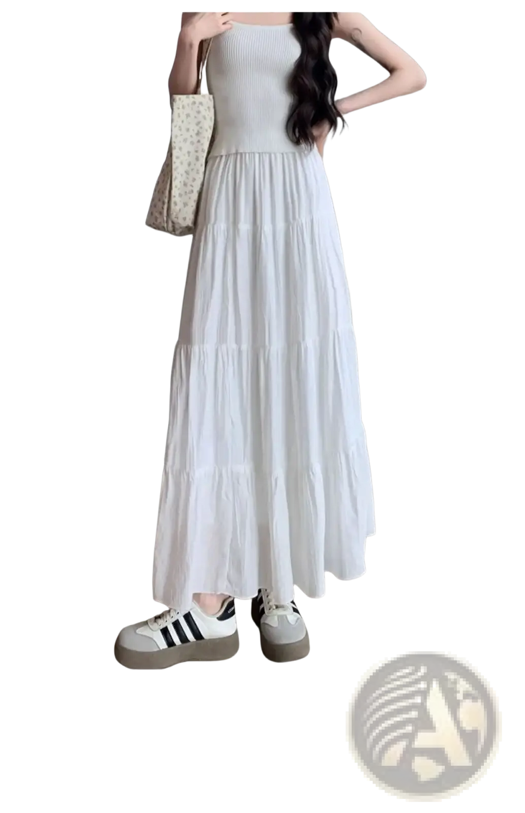 White pleated tiered maxi skirt featuring a flowing white tiered design with a ribbed bodice in soft lightweight fabric