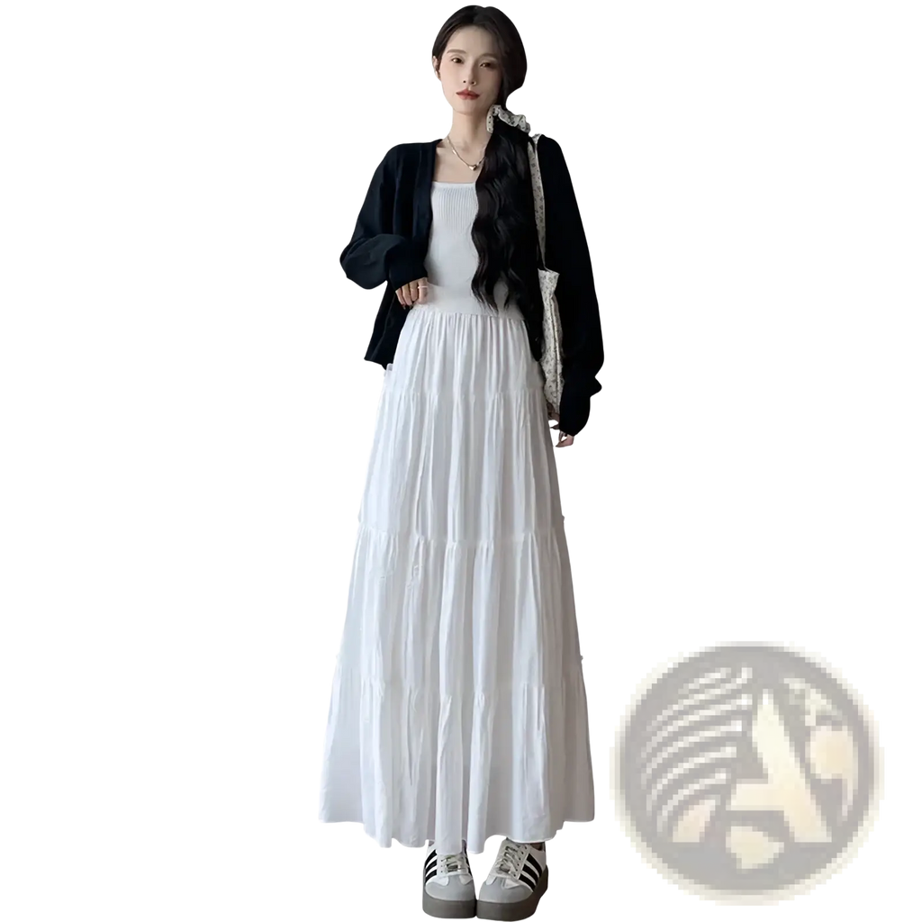 White pleated tiered maxi skirt with flowing lightweight fabric and subtle pleats for elegant casual wear