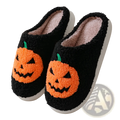 Black fuzzy slip-on slippers with orange embroidered jack-o-lantern faces green stems and plush pink interior lining