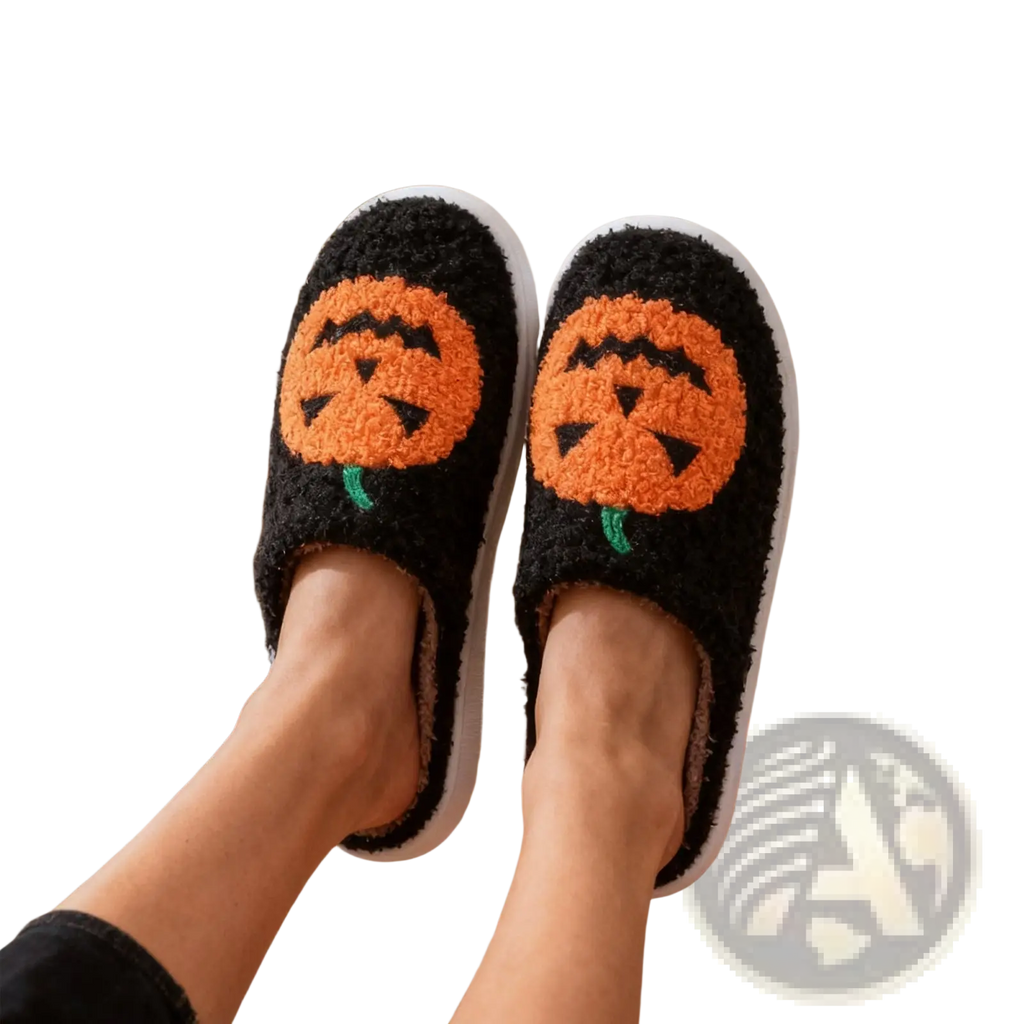 Black fuzzy halloween slippers with orange jack-o-lantern embroidery and white soles in white plush design