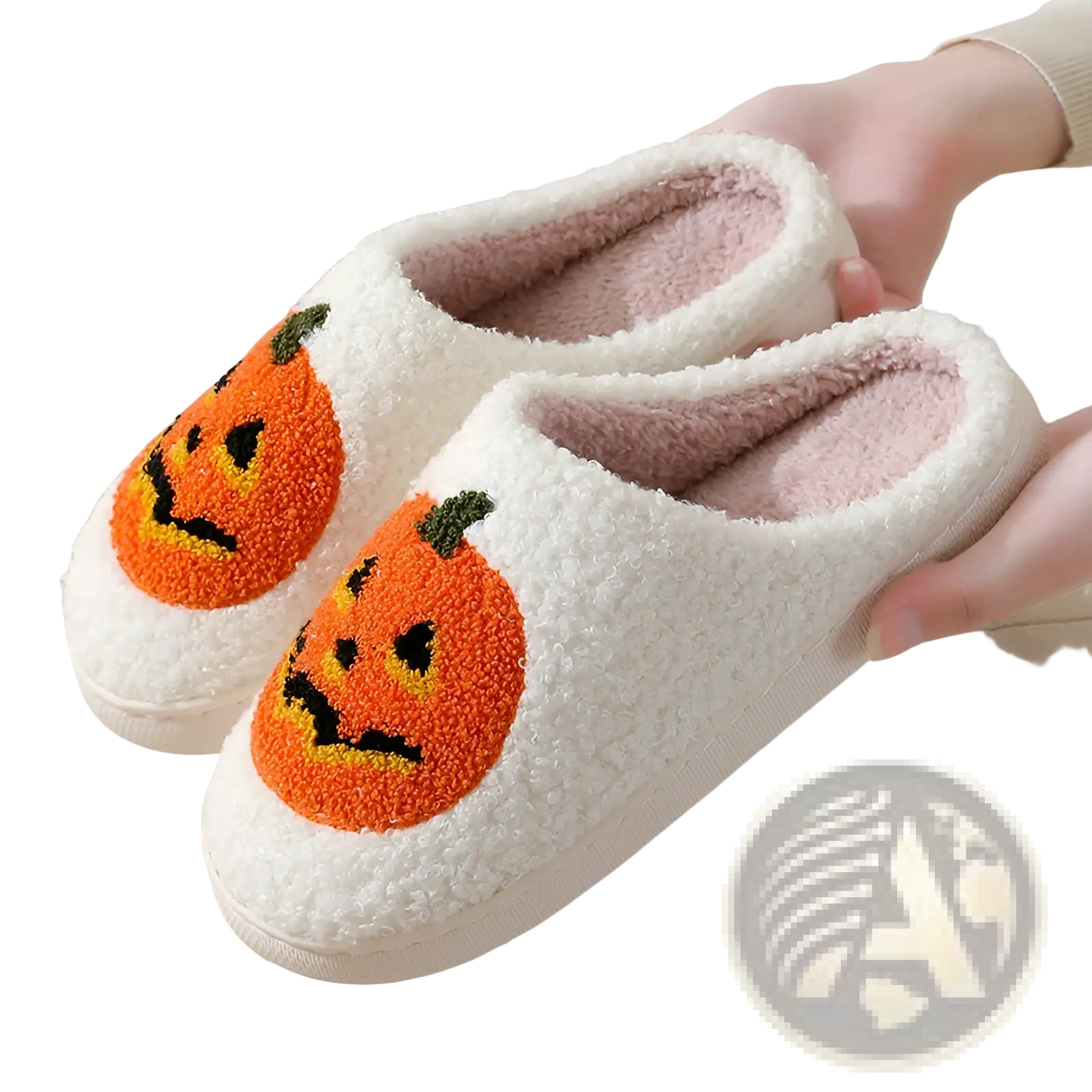 White plush halloween slippers with orange embroidered jack-o-lantern faces on the front