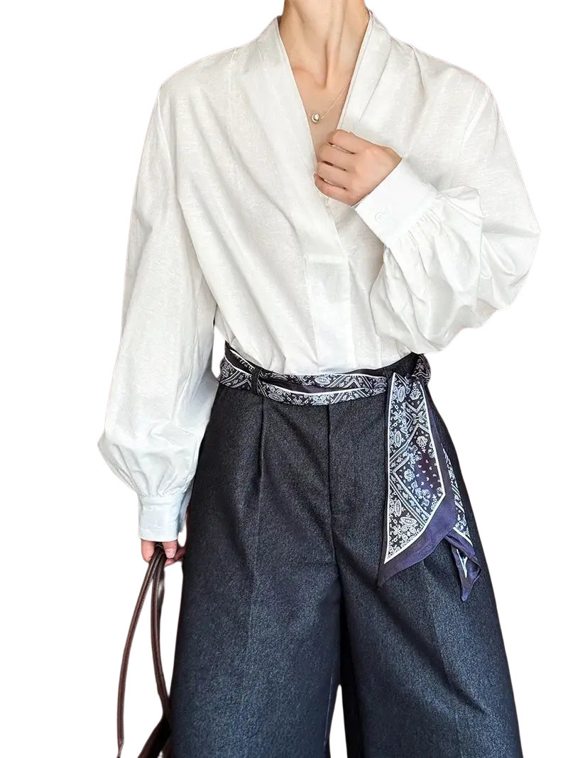 White puff sleeve v neck blouse in lightweight fabric with long loose fit and voluminous cuffs for elegant wear