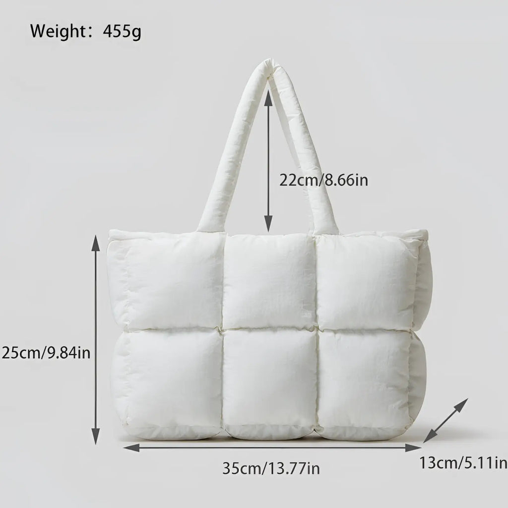 White quilted puffer tote bag with padded segmented design and soft cotton fabric handles for everyday use