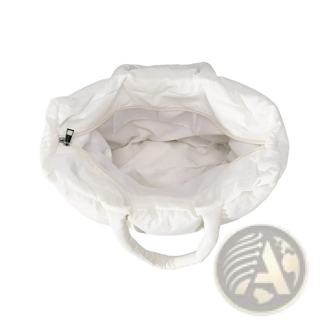 White quilted puffer tote bag with soft cotton fabric and matching handles for stylish everyday use