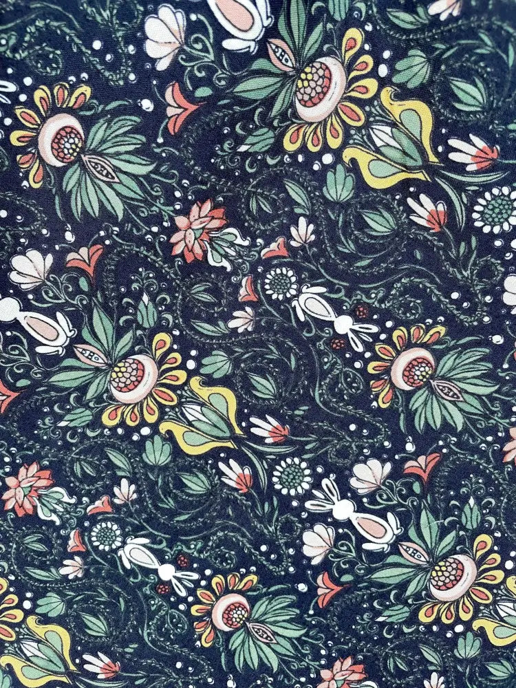 White rabbit black floral midi dress with yellow belt featuring dark blue fabric with vibrant yellow green pink and white blossoms
