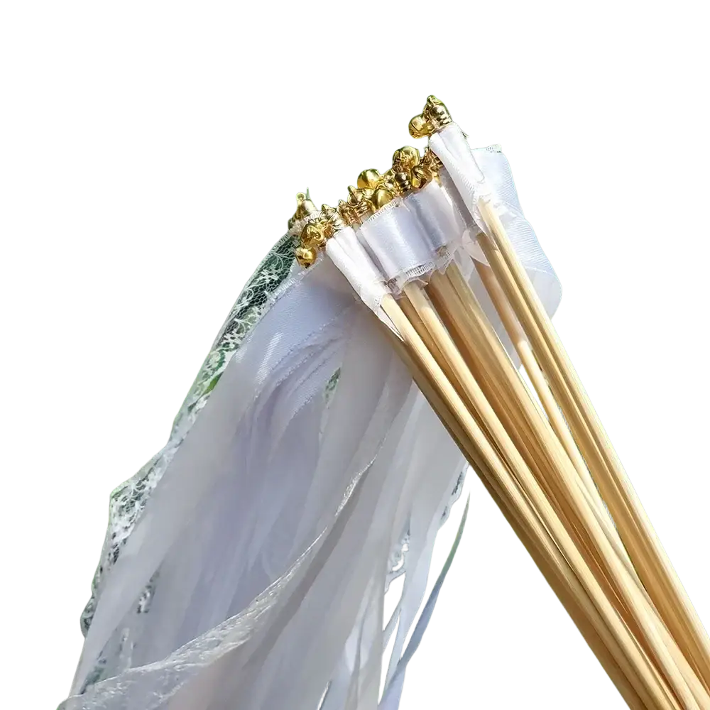 White ribbon wedding wands with delicate white lace-tipped bells and golden metallic tops on slender wooden sticks