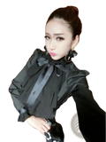 Black long sleeve ruffled blouse with a prominent bow at the neckline made of lightweight fabric