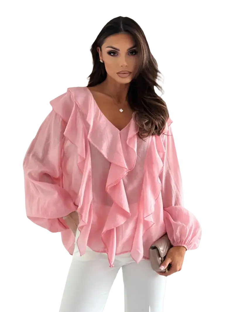A soft pink sheer blouse with layered ruffles at the neckline and puff sleeves in a white ruffled v neck style