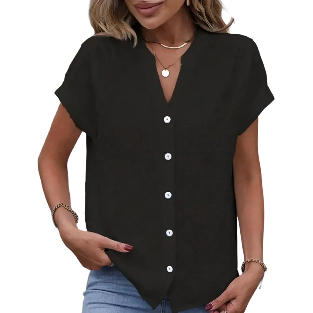 Black short-sleeved blouse with white buttons and v-neckline featuring a classic sleeve length and style