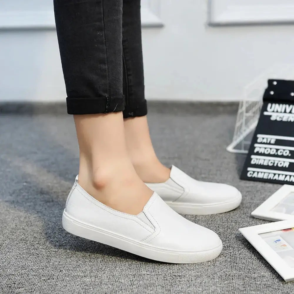 Women’s minimalist korean style white leather slip-on sneakers with a clean and simple design