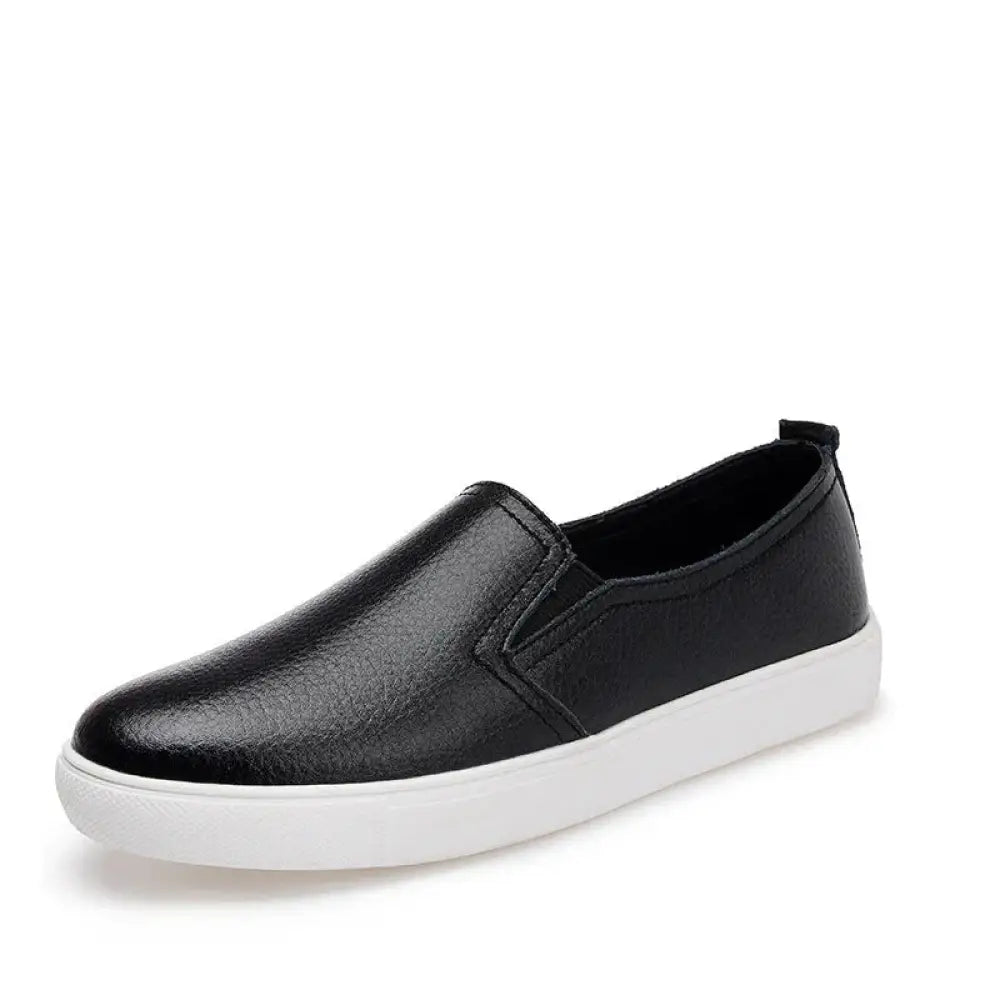 Black slip-on sneaker with textured leather upper and white rubber sole for women’s minimalist Korean style wear