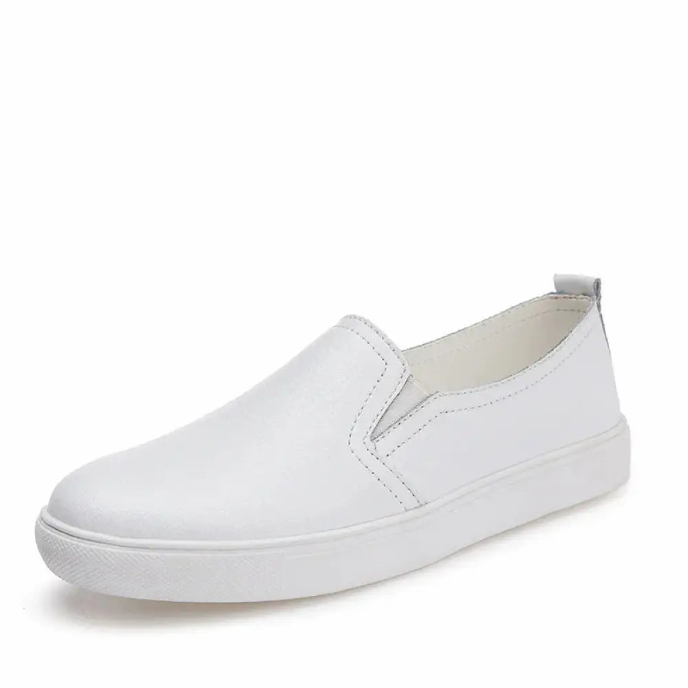 White leather slip-on sneaker with minimalist design and matching white rubber sole for women’s Korean style footwear