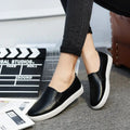 Black women’s minimalist Korean style leather slip-on sneakers with smooth leather upper and white rubber sole