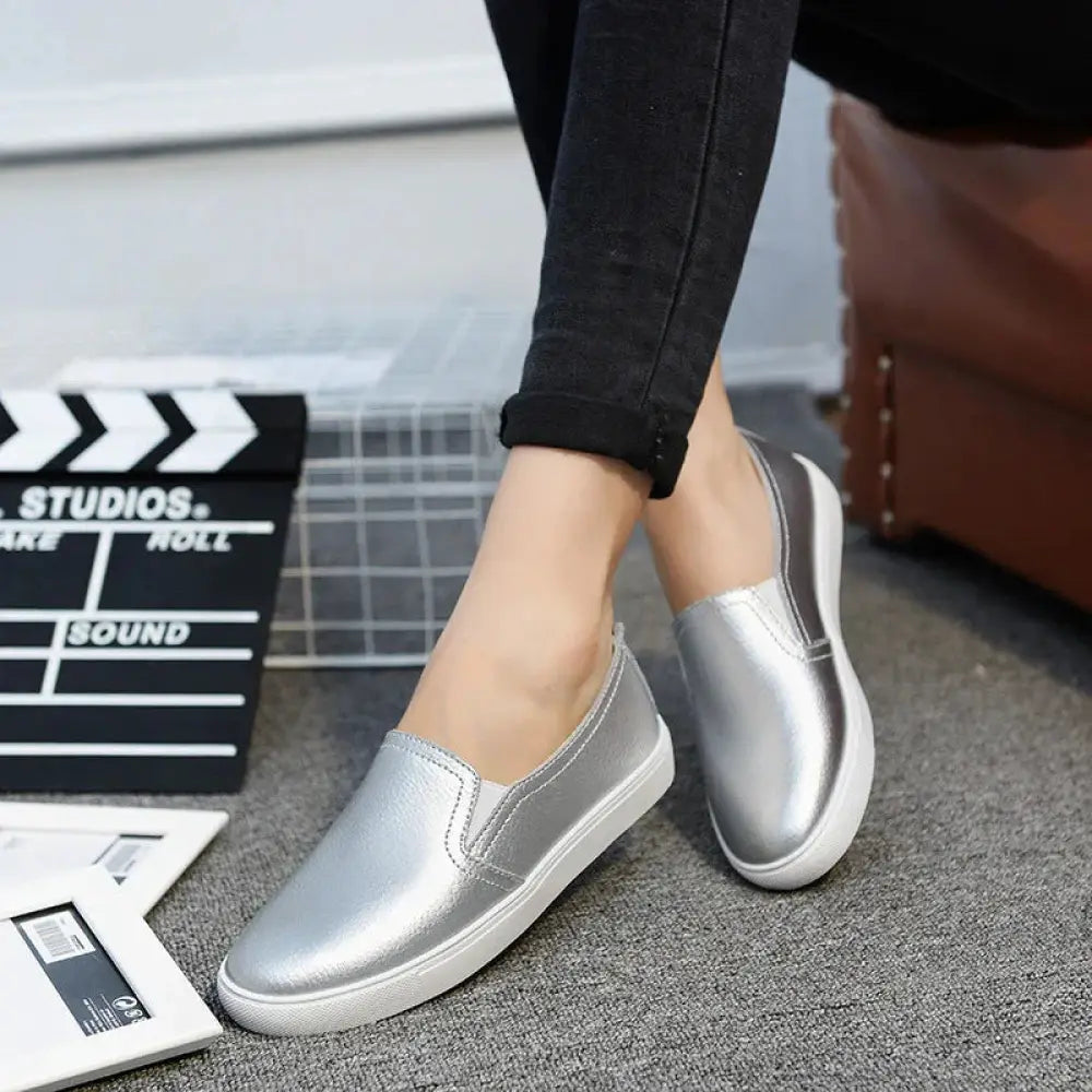 Women’s minimalist korean style silver leather slip-on sneakers with a glossy finish and white rubber soles