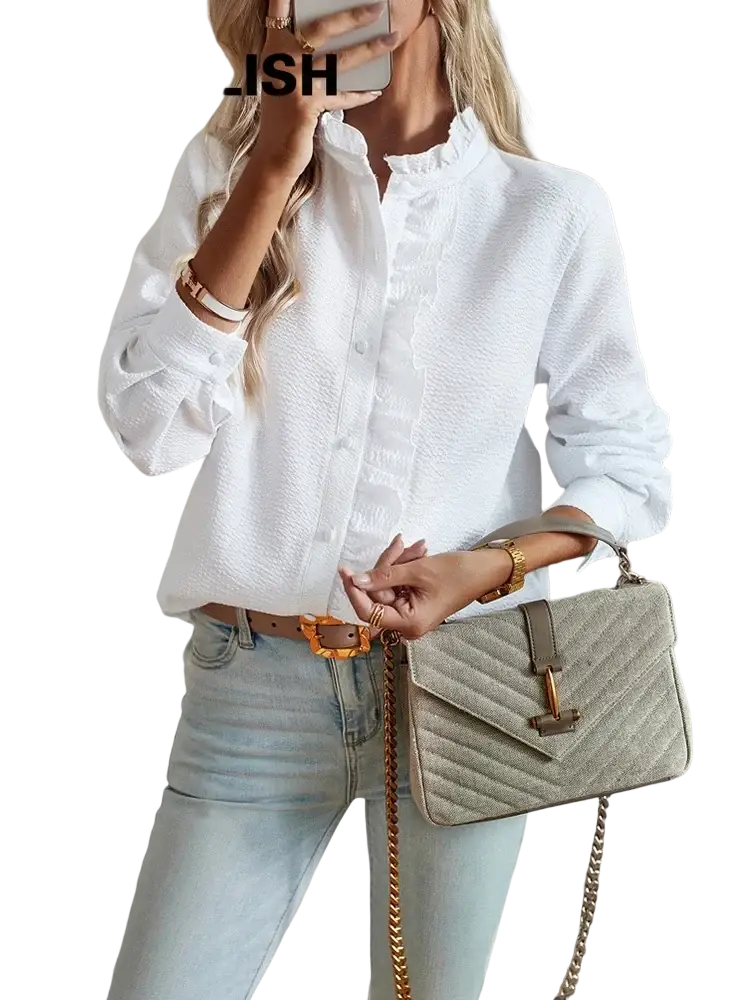Beige quilted handbag with gold-tone chain strap and metallic clasp shown with white textured long sleeve ruffled blouse