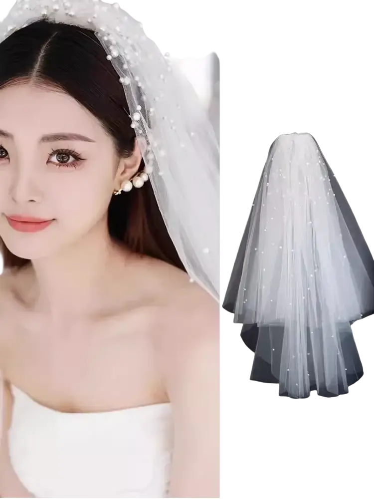 White tulle bow bridal veil featuring layered design with delicate pearl embellishments by shalishawai