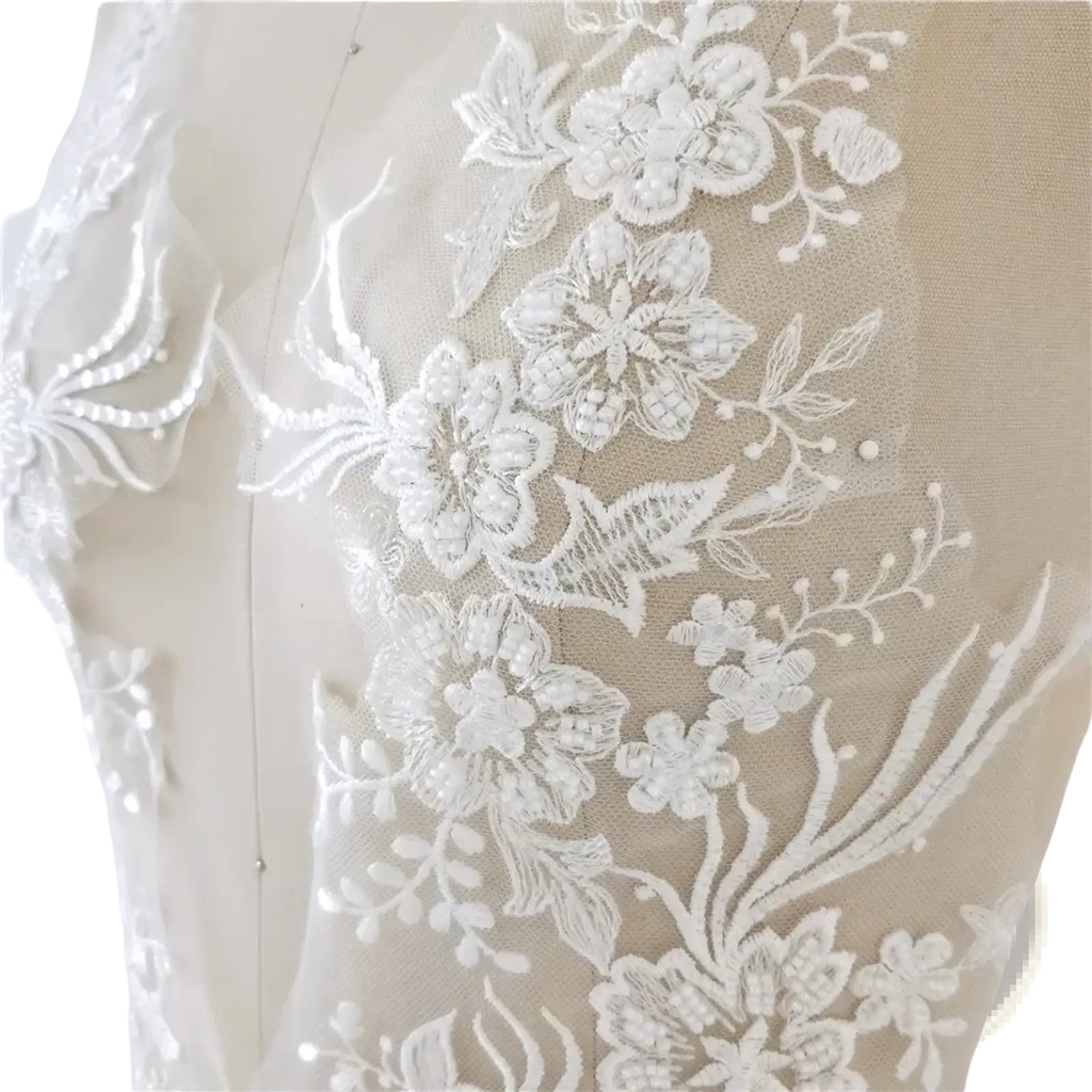 White wedding dress lace applique pair featuring white floral lace trim with embroidered flowers leaf patterns and pearl beads