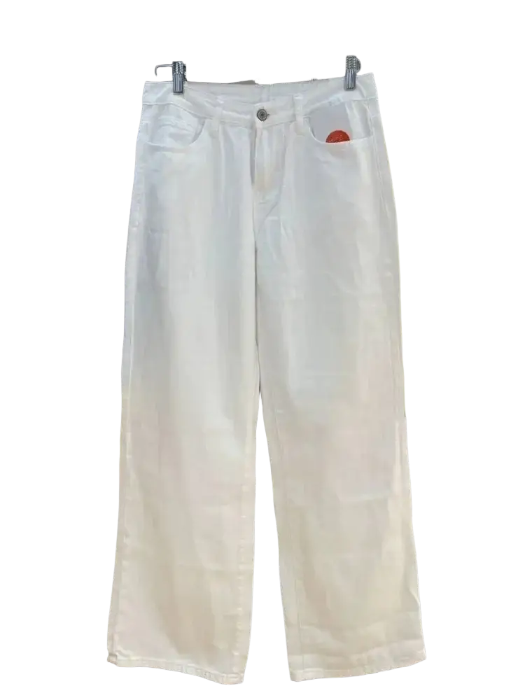 White wide leg denim pants featuring white denim material with a subtle red circular patch on the front pocket
