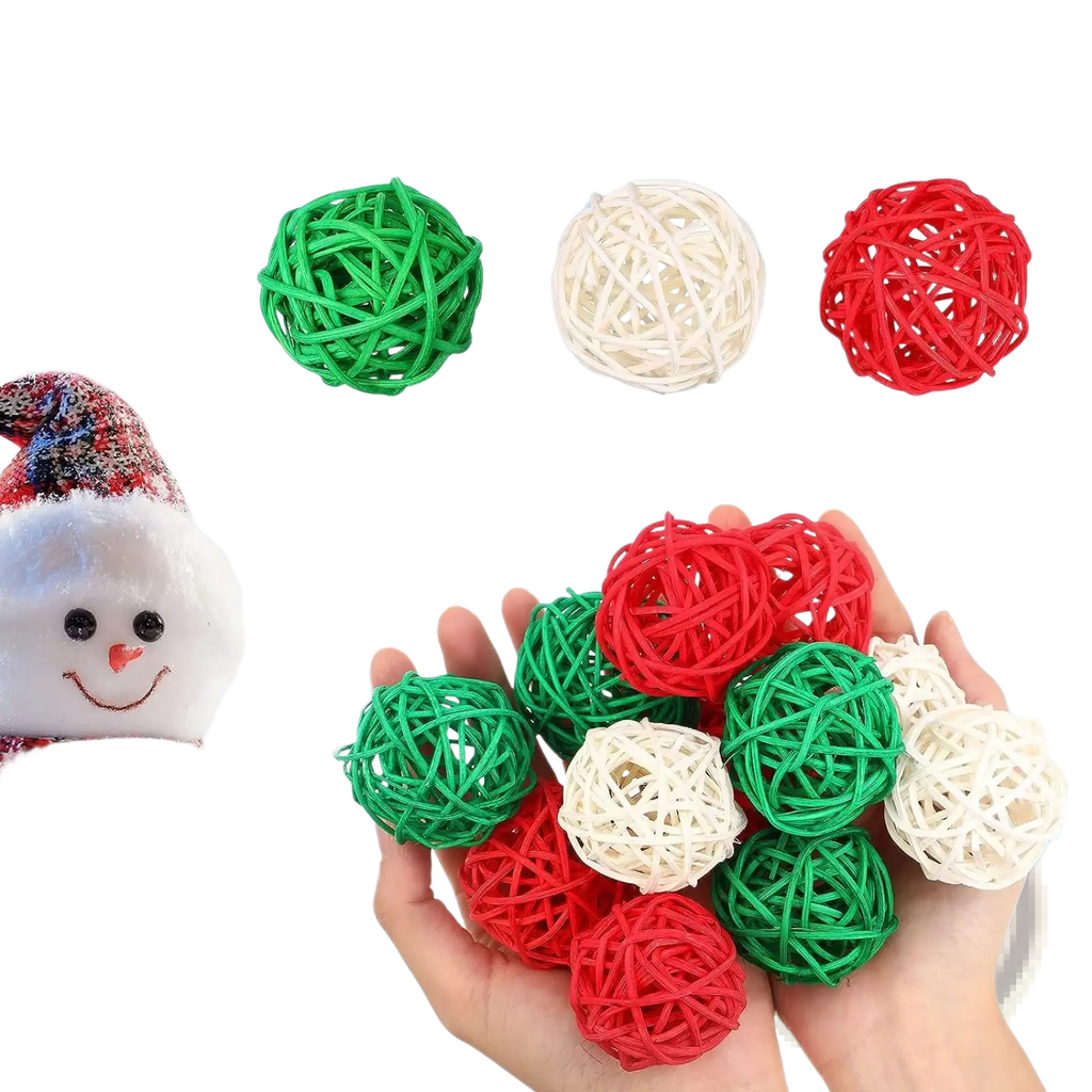 Hand holding small woven wicker rattan balls in red green and white for christmas vase filler orbs 30pc set