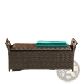 Brown wicker storage bench with matching lid and rolled-up teal towel for outdoor seating use