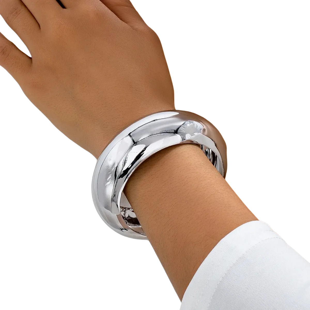 Wide gold bangle bracelet for women with sleek silver finish smooth reflective surface and subtle geometric contours