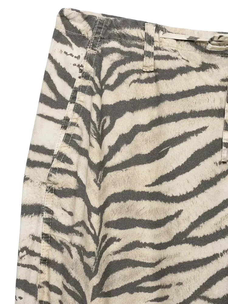 Wide leg cargo pants in beige and black zebra-print denim with a faded, distressed texture