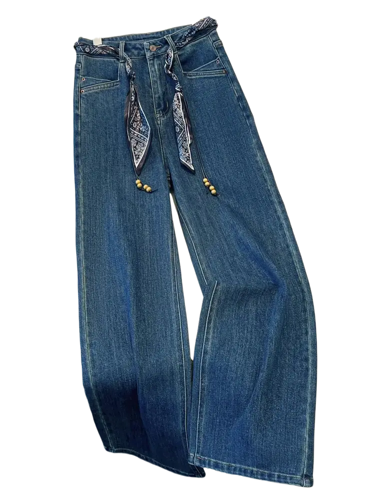 Blue denim wide leg jeans with decorative scarf belt featuring patterned fabric ties and wooden beads at the waist
