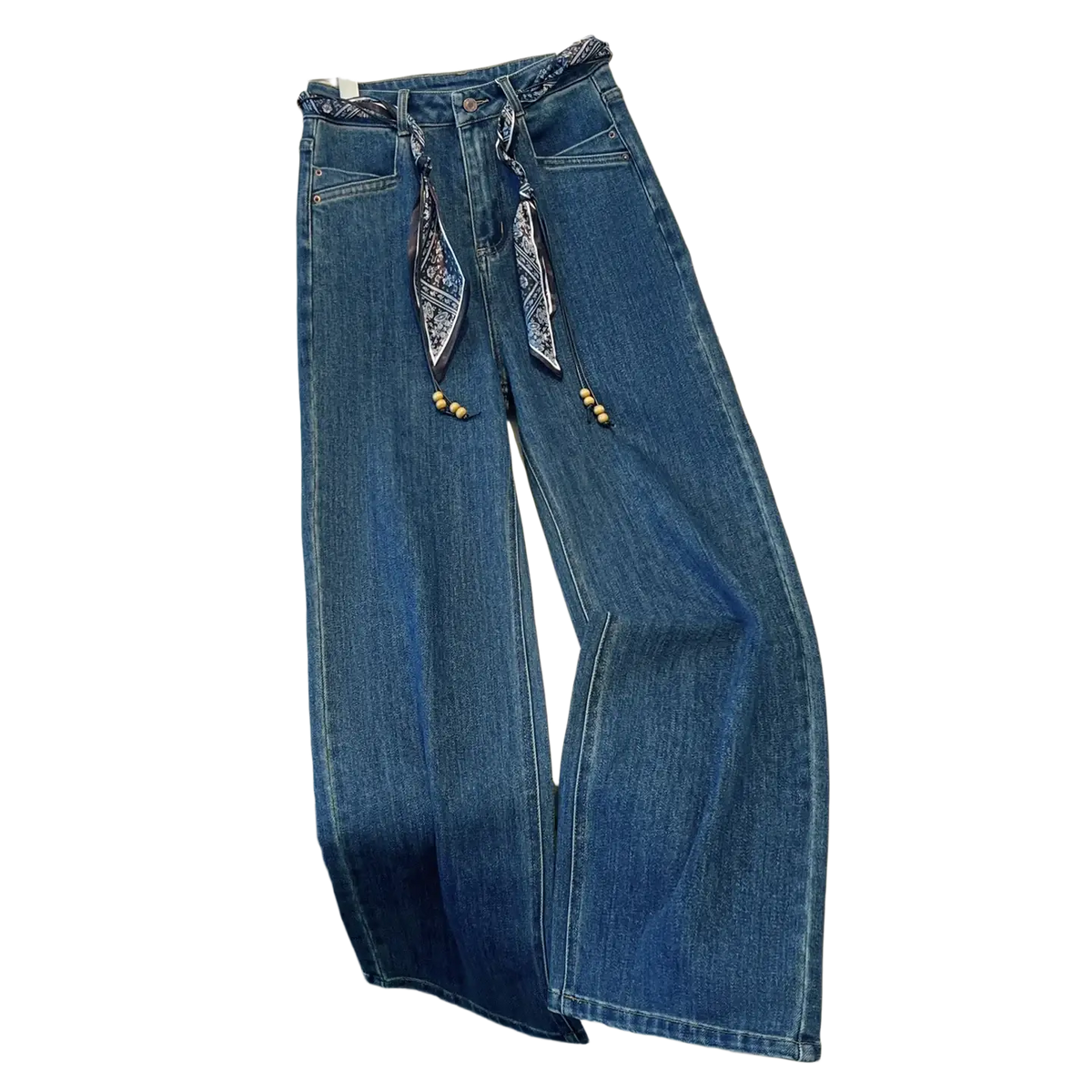 Wide leg blue denim jeans featuring a decorative patterned scarf belt with wooden beads tied at the waist