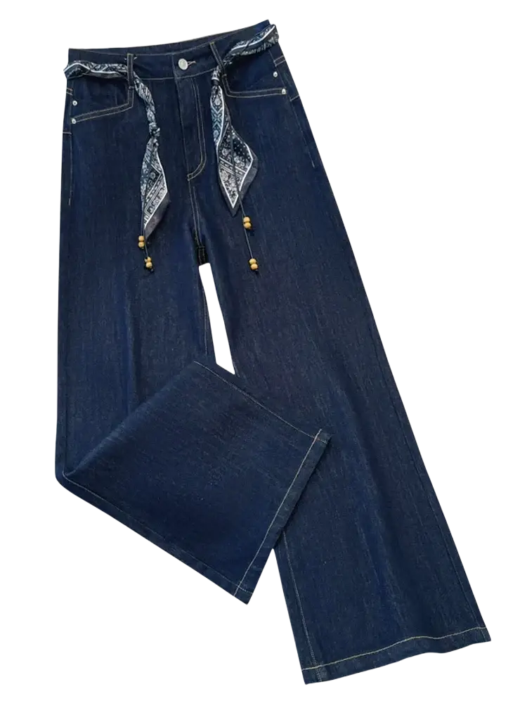 Wide leg dark blue denim jeans with a patterned bandana scarf belt and wooden bead accents on belt loops